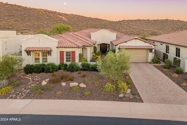 mediterranean / spanish-style home with a garage