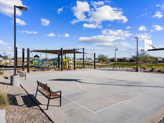 view of property's community with a playground and basketball hoop