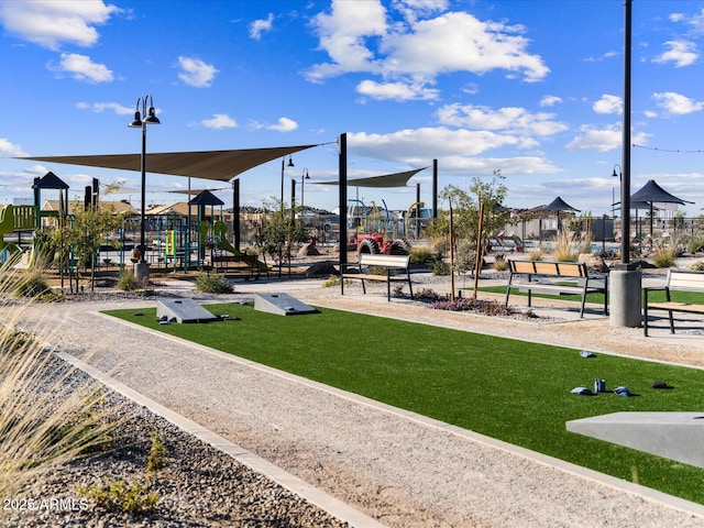 surrounding community featuring a playground and a lawn