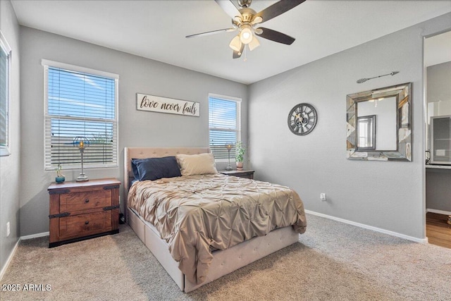 carpeted bedroom featuring baseboards and ceiling fan