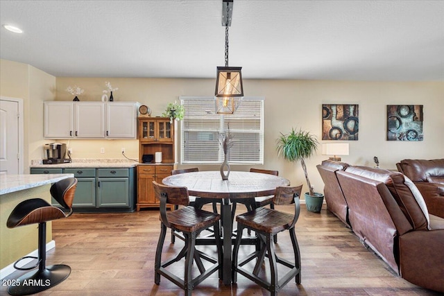 dining room with recessed lighting and light wood finished floors