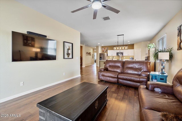 living room with ceiling fan, baseboards, dark wood-style floors, and visible vents