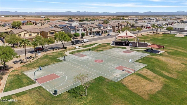 view of sport court featuring a residential view, a yard, a mountain view, community basketball court, and a gazebo