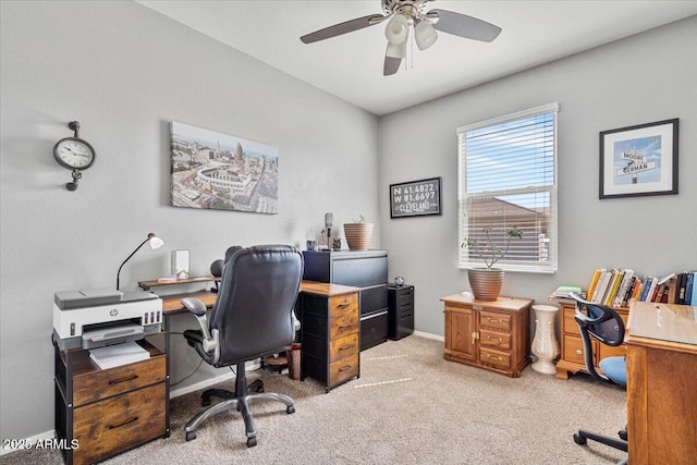 office space with light carpet, baseboards, and a ceiling fan