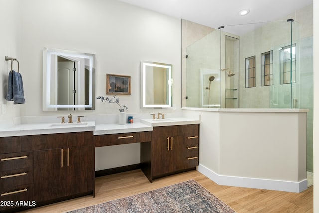 full bathroom with vanity, recessed lighting, wood finished floors, and tiled shower