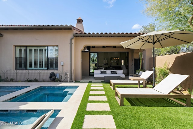 rear view of property with stucco siding, an outdoor hangout area, a yard, a patio area, and an outdoor pool