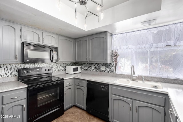 kitchen featuring gray cabinets, light countertops, and black appliances