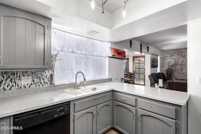 kitchen featuring a sink, light countertops, dishwasher, and gray cabinetry