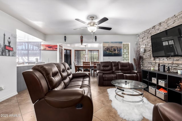 living room with ceiling fan and light tile patterned floors