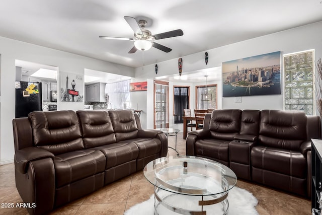 living room with ceiling fan and light tile patterned floors