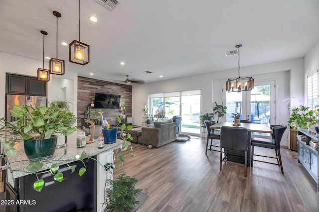 dining room with dark wood-type flooring, ceiling fan, and french doors