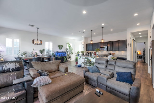 living room featuring hardwood / wood-style flooring and a chandelier