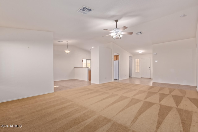 unfurnished living room featuring light carpet, vaulted ceiling, and ceiling fan