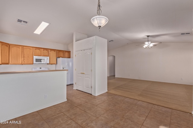 kitchen featuring white appliances, ceiling fan, light carpet, vaulted ceiling, and pendant lighting