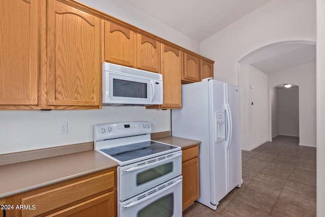 kitchen with white appliances and light tile patterned floors