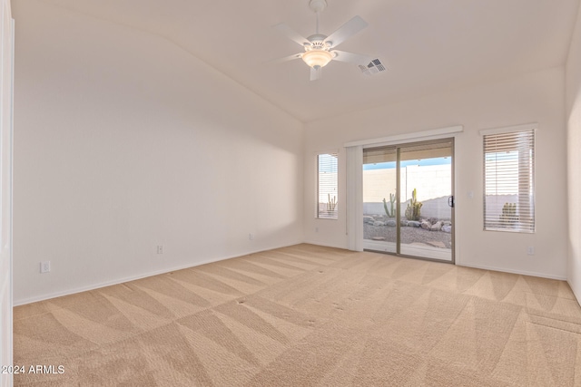 carpeted spare room with lofted ceiling and ceiling fan