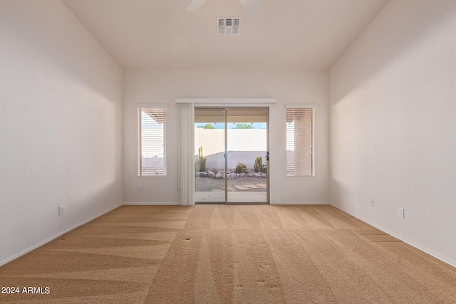 carpeted spare room with a mountain view and ceiling fan