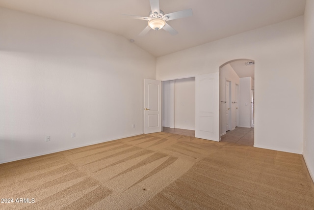 unfurnished bedroom with ceiling fan, light carpet, and lofted ceiling