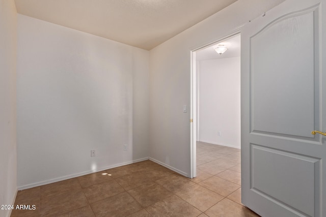 empty room with light tile patterned floors