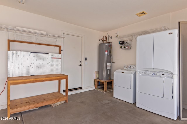 washroom with washer and clothes dryer and electric water heater