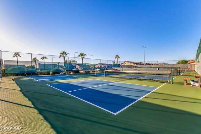 view of tennis court featuring basketball hoop