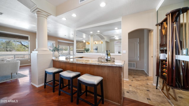 interior space featuring visible vents, light wood-style flooring, recessed lighting, decorative columns, and ceiling fan