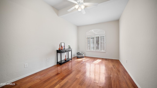 spare room featuring ceiling fan, baseboards, and wood finished floors