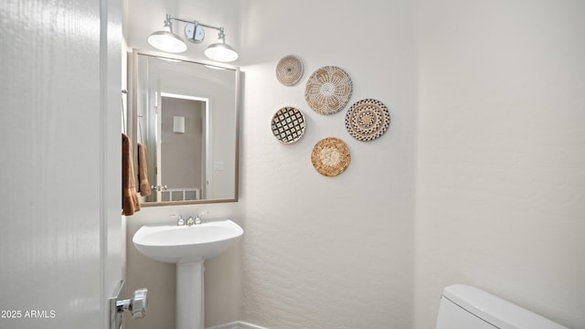 bathroom featuring toilet and a sink