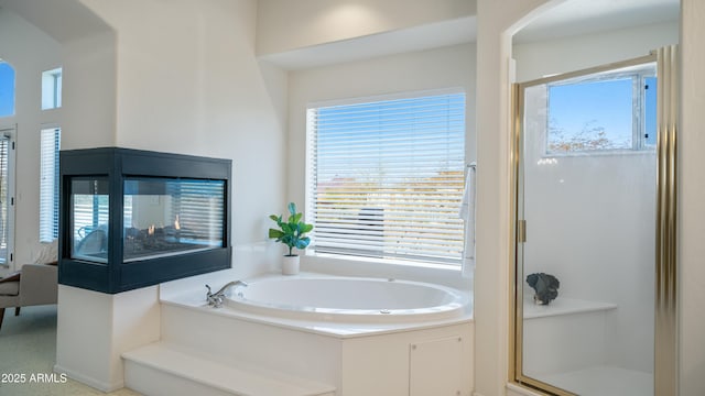 full bath with a shower stall and a garden tub