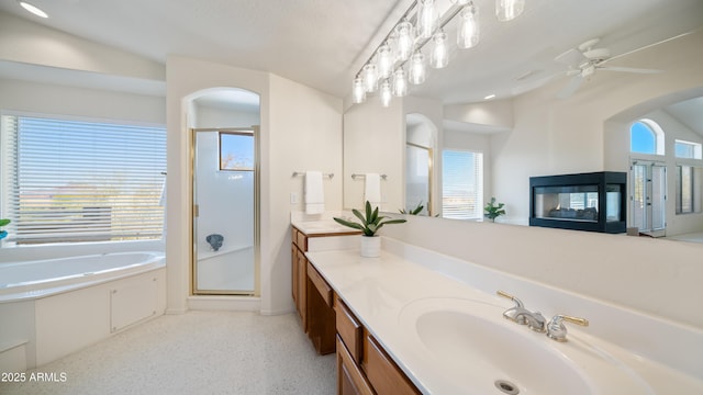 full bath featuring vanity, a shower stall, a bath, and ceiling fan