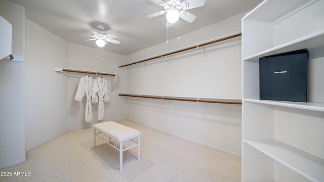 walk in closet featuring a ceiling fan