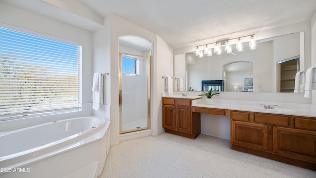 bathroom featuring carpet, double vanity, a sink, a shower stall, and a bath