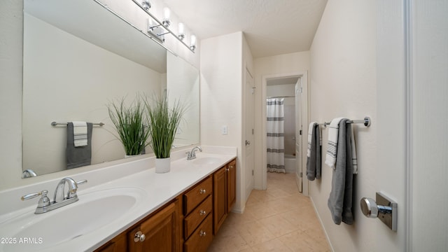 bathroom featuring tile patterned floors, shower / bath combination with curtain, double vanity, and a sink