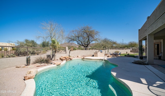 view of swimming pool featuring a fenced in pool, a fenced backyard, and a patio area