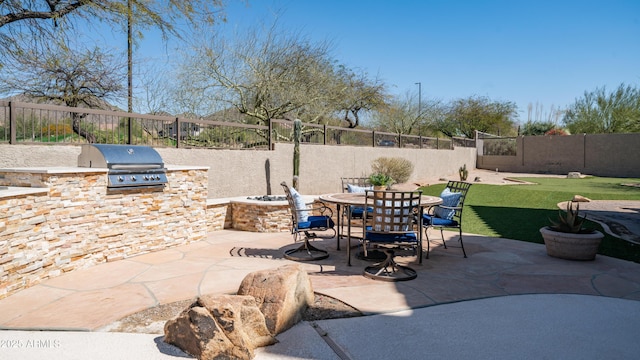 view of patio featuring area for grilling, a grill, a fenced backyard, and outdoor dining space