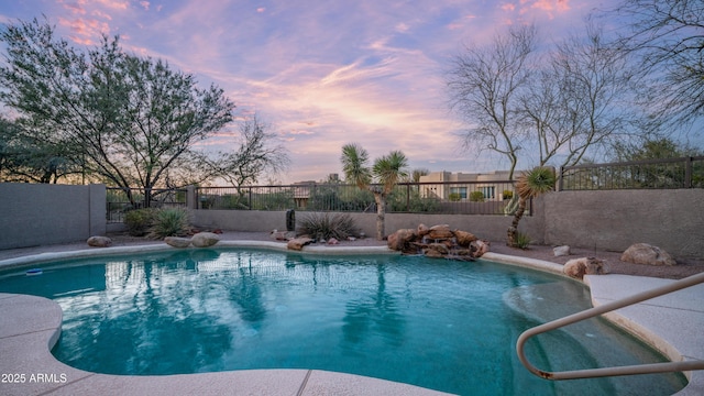 pool at dusk featuring a fenced in pool and fence