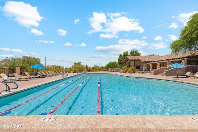 pool featuring a patio area and fence