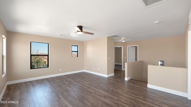 spare room with dark hardwood / wood-style floors and ceiling fan