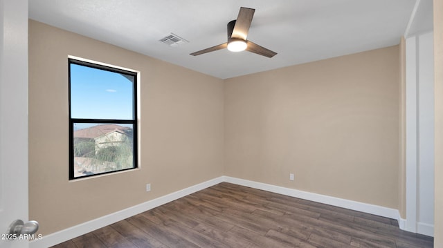 empty room with ceiling fan and dark wood-type flooring