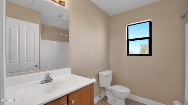 bathroom with tile patterned flooring, vanity, and toilet