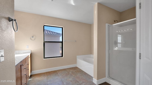 bathroom featuring vanity and independent shower and bath