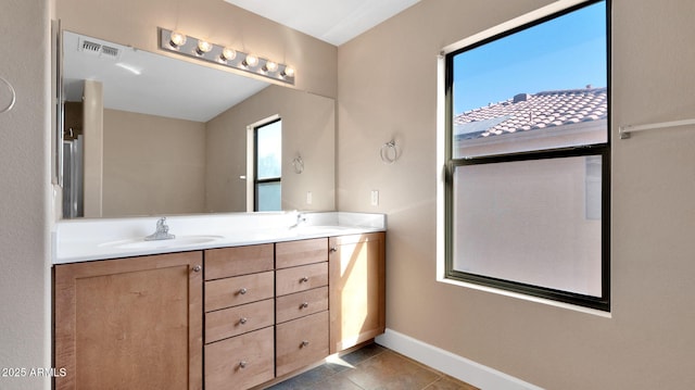 bathroom with tile patterned flooring and vanity