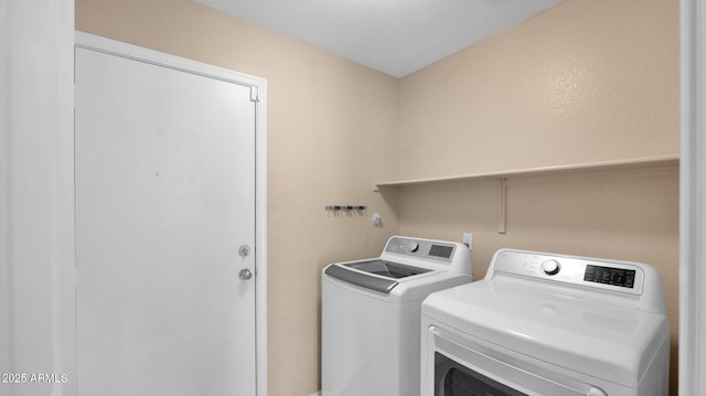 clothes washing area featuring washer and clothes dryer