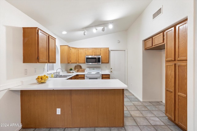 kitchen featuring white electric range oven, kitchen peninsula, vaulted ceiling, and sink