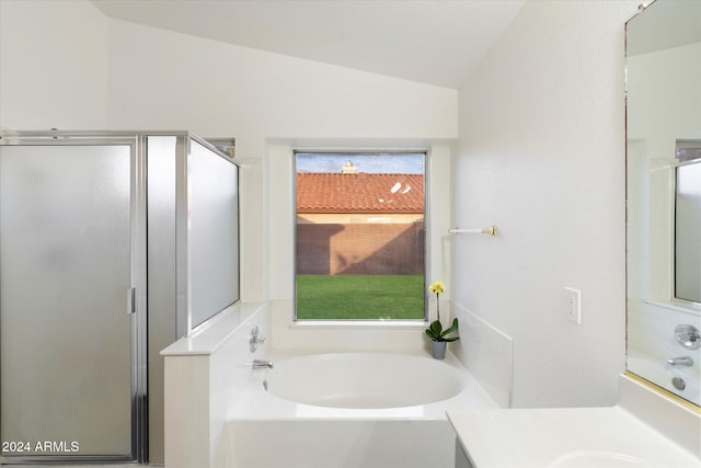 bathroom with plus walk in shower, vanity, and vaulted ceiling