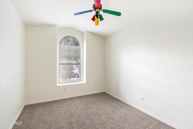 spare room with carpet flooring, ceiling fan, plenty of natural light, and lofted ceiling