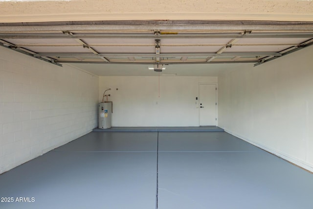 garage with concrete block wall, a garage door opener, and water heater