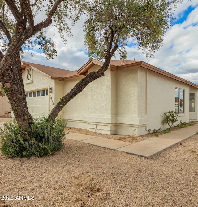 view of front facade featuring an attached garage and stucco siding