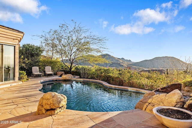 view of pool featuring a mountain view and a patio