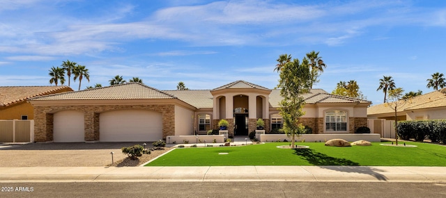 mediterranean / spanish-style home featuring stucco siding, a front yard, fence, a garage, and stone siding